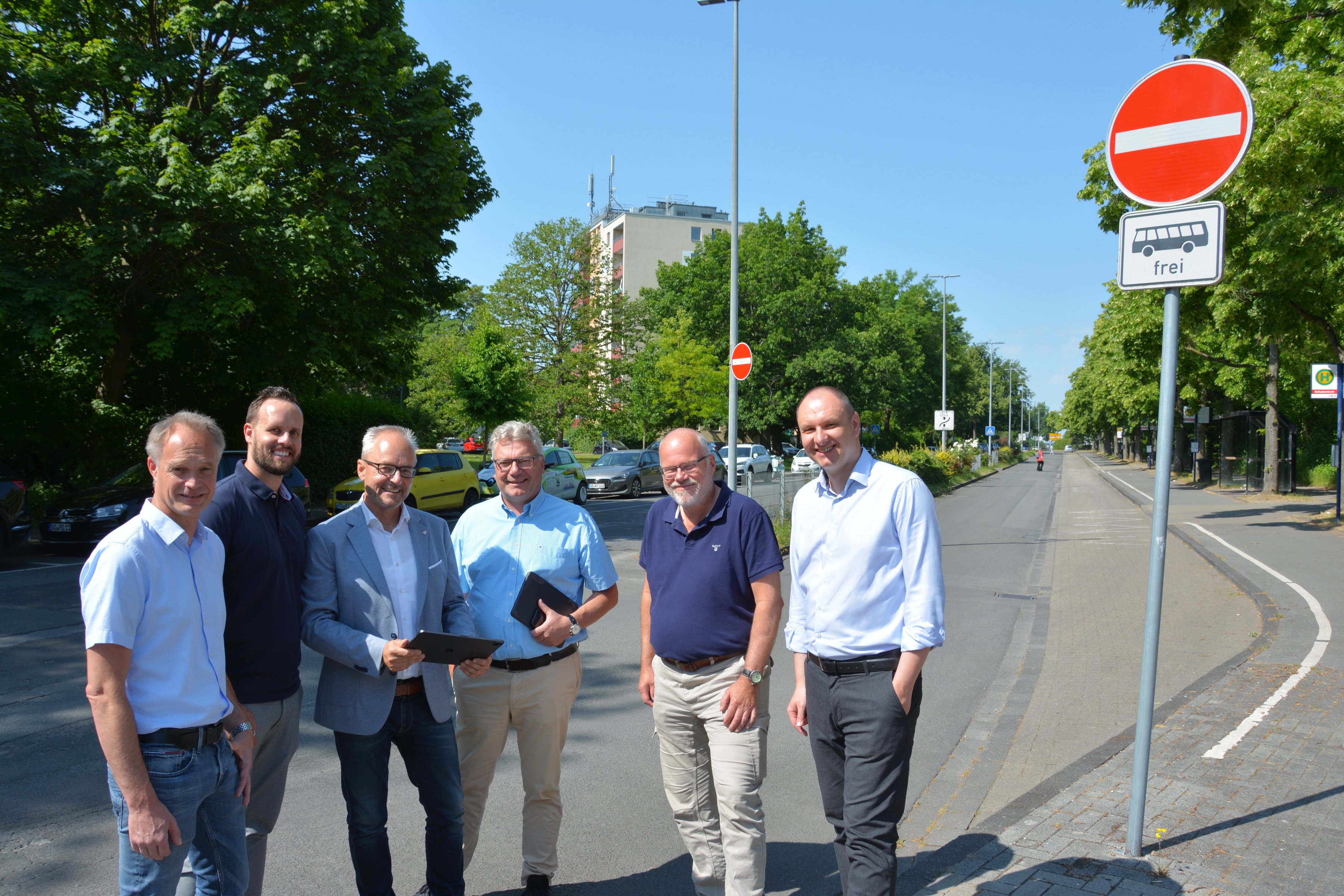 Vertreter der Stadtwerke und der Stadt stehen auf dem Gehweg am Paradieser Weg .